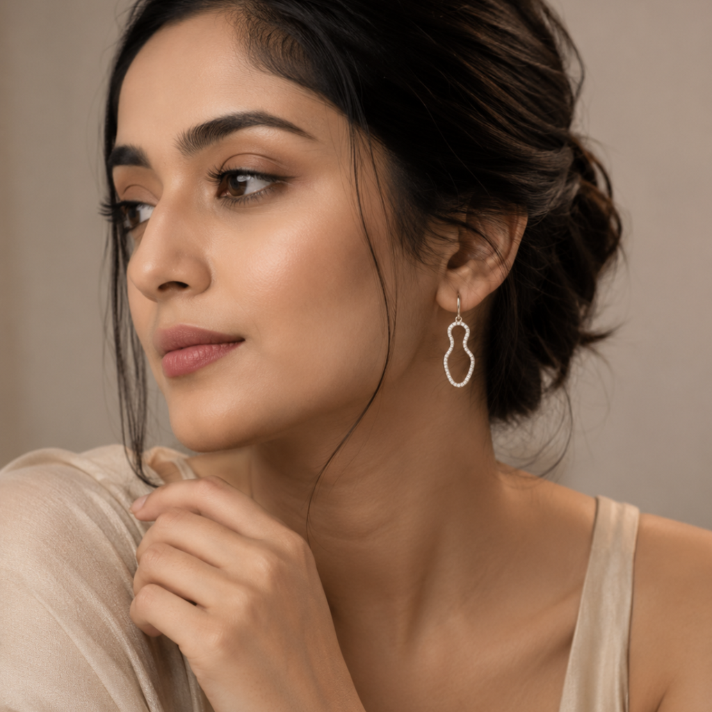 Woman wearing Aura Wave Drop earring against a neutral background
