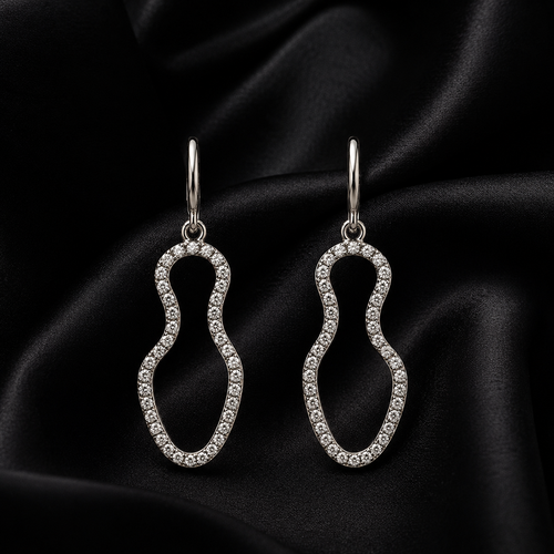 Pair of Aura Wave Drop earrings on a black satin fabric