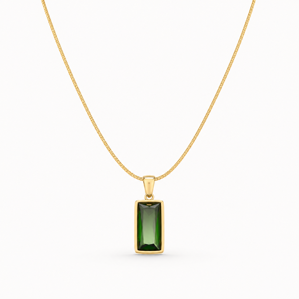 Gold necklace with a green gemstone pendant on a white background