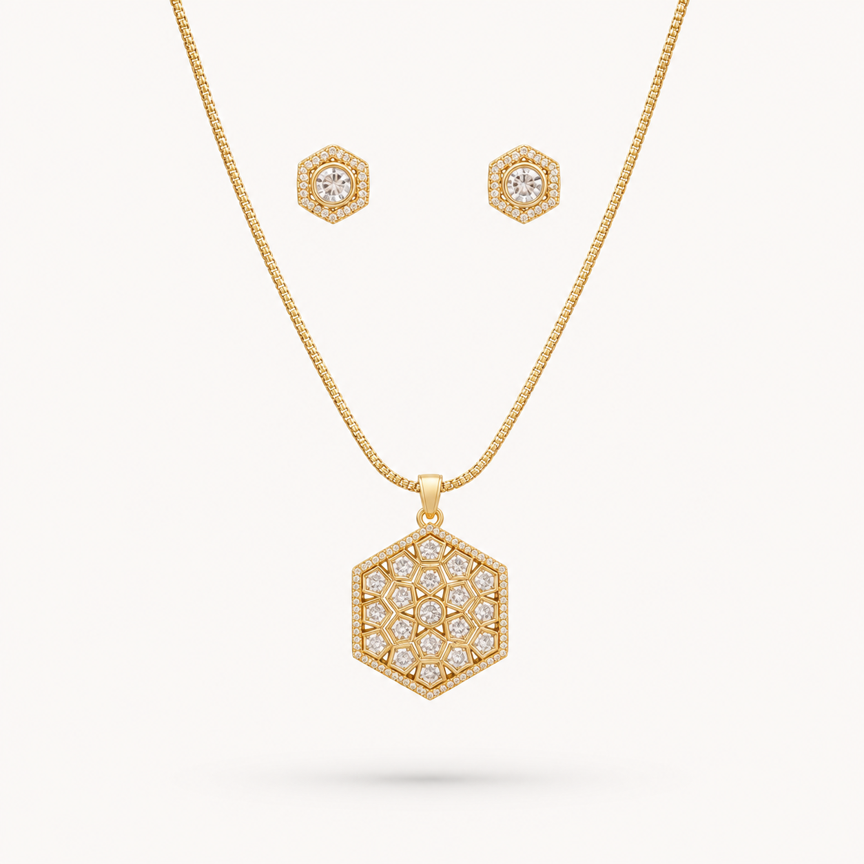 Gold necklace and earrings set on a white background