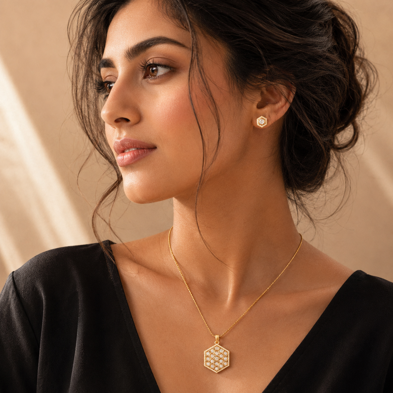 Model wearing a gold necklace and earring set