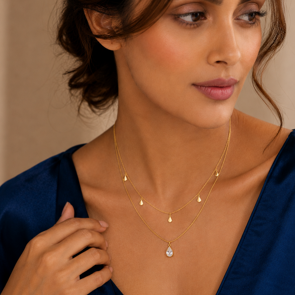 Woman wearing Layered Teardrop Pendant with a blue top 