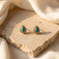 Turquoise-Blue Teardrop Studs on a textured stone surface.